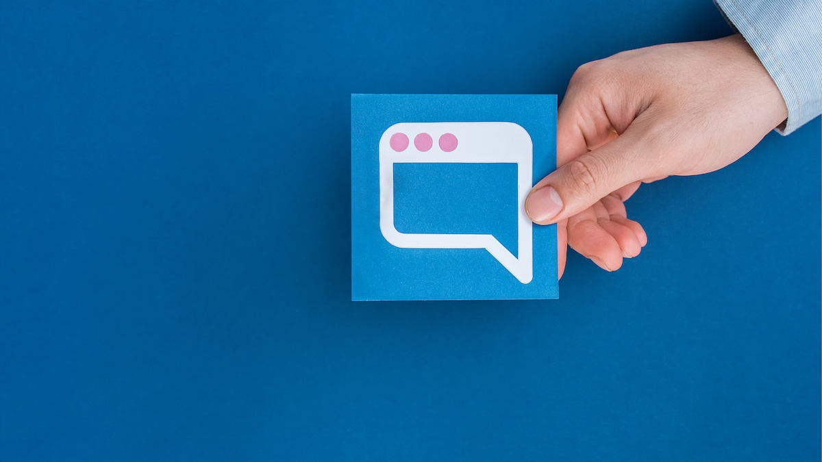 Digital marketer analyzing Facebook Ads updates on a laptop in a modern office.