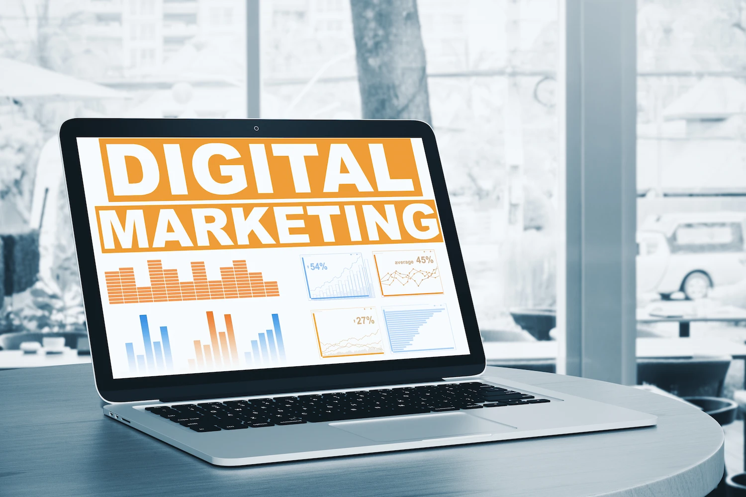 Laptop displaying "Digital Marketing" with analytics dashboards showing campaign performance charts — Meta Ads budget management for local businesses